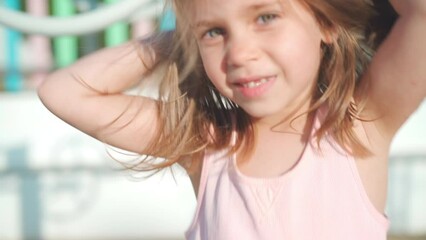 Child playing on playground warm summer day. Little girl have fun. Happy childhood. Caucasian little girl 5 years play outdoor hanging upside down