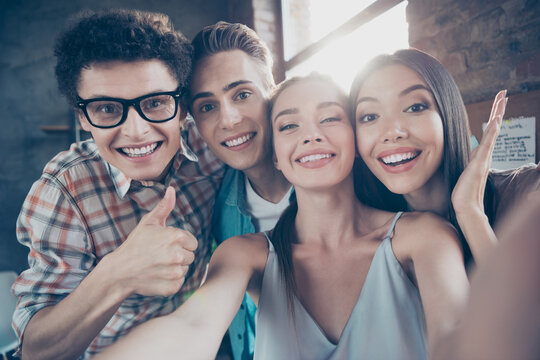 Photo of charming good mood groupmates buddies take selfie together show thumb-up enjoy university life