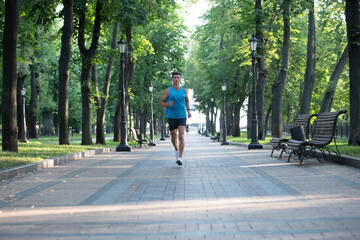 athletic man runner running in sportswear outdoor. full length