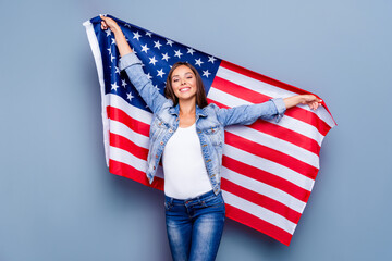 Portrait of attractive positive satisfied lady hold national american flag isolated on grey color...