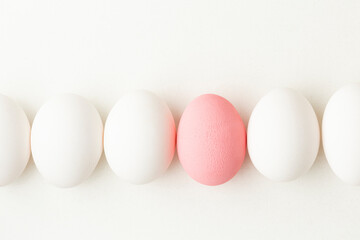 Eggs, one pink and the other white, coceptual photo