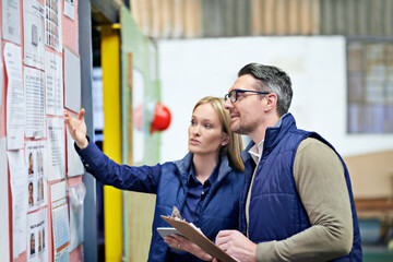 This all needs updating. Cropped shot of a two coworkers managing a warehouse.