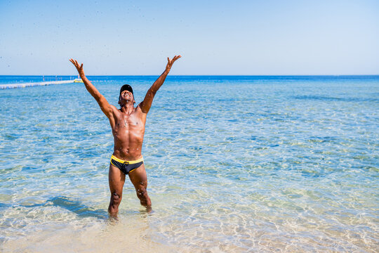African-American boy celebrating and smiling on the beach for the arrival of summer