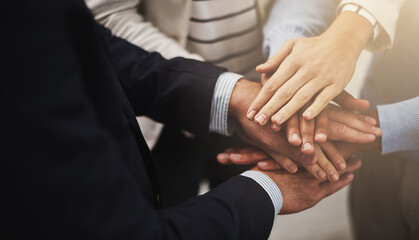 Where there is unity there is victory. Cropped shot of a group of businesspeople putting their...