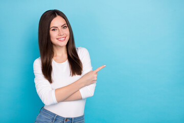 Portrait of attractive cheerful girl showing copy blank empty space ad offer isolated over brigth blue color background