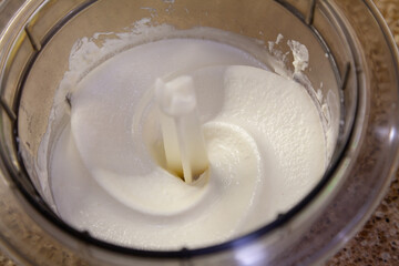 White confectionery cream in a round transparent container....
