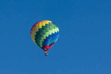 Colorful hot air balloon in a clear blue sky