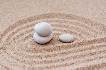 Fototapeta na wymiar Sand and stone for harmony and balance. Zen stone concept