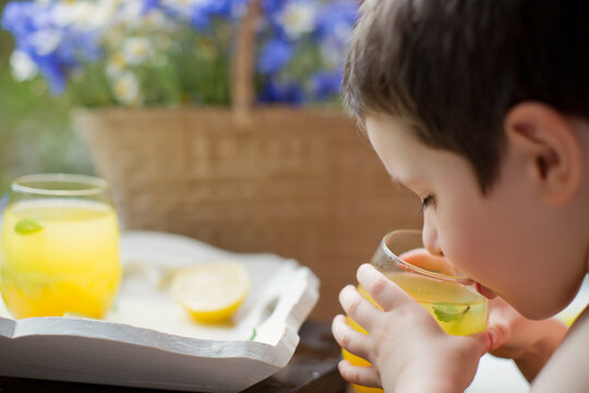 Child drinks lemonade, summer drinks