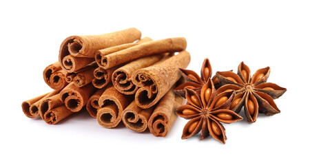 Aromatic cinnamon sticks and anise stars with seeds on white background