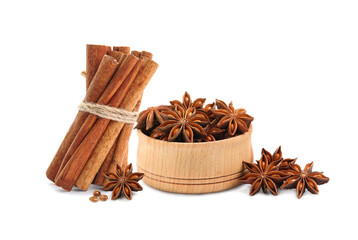 Aromatic cinnamon sticks and anise stars with seeds on white background