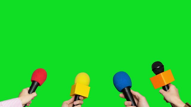 Microphones in the hands of journalists for interview on green screen background. Conference meeting microphones prepared for talker isolated on chroma key background
