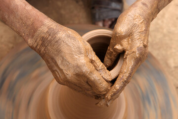 close up of hands of a potter