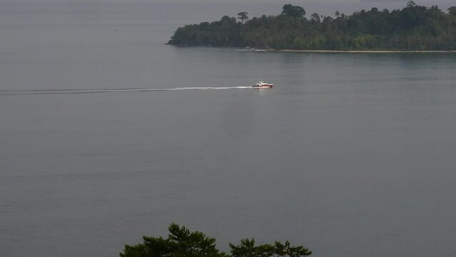 Morning view on Air Manis beach, West Sumatra with overcast sky. Air Manis Beach is closely related to the legend of Malin Kundang. HD videos of ships passing by.