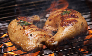 Grilled chicken Leg on the grill. appetizing grilled juicy chicken with golden brown crust served...