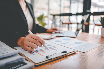 Portrait of a woman working on a tablet computer in a modern office. Make an account analysis report. real estate investment information financial and tax system concepts