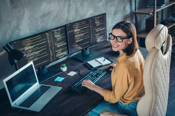 Profile side view portrait of attractive cheerful girl geek providing service cyber security at workplace workstation indoors