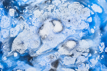 Blue ink abstract background, winter paint pattern under water, acrylic pigment stains, splashes and streaks