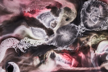 Ink abstract background, black white red paint pattern underwater, acrylic pigment stains, splashes and streaks