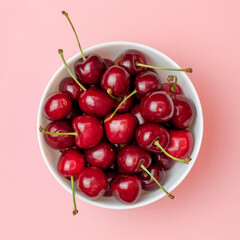 Fresh cherry in a plateon a pink background , sweet eating, Top view.