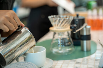 Cafe staff at work,Barista is Making a Cup of Cappuccino in Coffee Shop Bar.