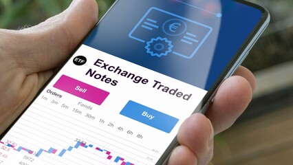 Invest in exchange traded notes fund etf, buy a fund. An investor's analyzing an ETF. 