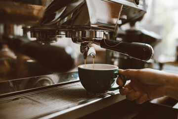 Selective focus barista making coffee with professional machine, Coffee pouring into a cup, small business, startup business.