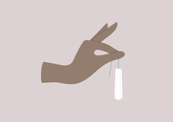 Menstrual protecting accessories, a hand holding a tampon