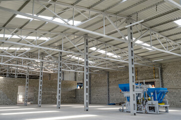 Interior of a paving plant. Empty industrial premises. A machine that produces paving slabs.