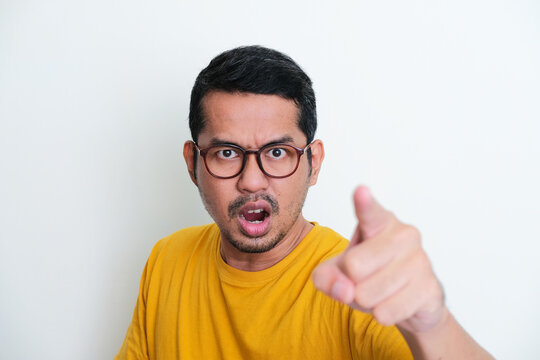 Closeup portrait of Adult Asian man pointing forward with angry expression