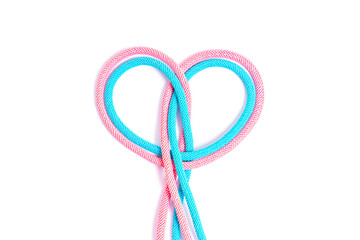 Heart symbol made from two colored cords on gray