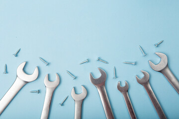 Top view of wrenches and nuts on blue background.Fathers day concept,good for man's offer.