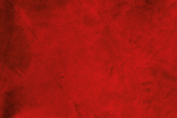 Red matte background of suede. Velvet texture of seamless leather. Red suede texture.