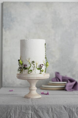 White wedding cake with lillac and green flowers