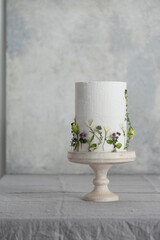 White wedding cake with lillac and green flowers