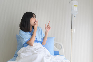 Hopeful and happy young patient woman in hospital, healthcare and medical concept