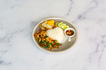 Obraz na płótnie Canvas basil pork fried rice thai food. Thai Food concept Khao pad krapow rice and minced beef Thai holy basil stir-fry with fried egg