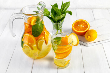 Citrus drink with lemon, orange and mint. Healthy and healthy drink in a transparent glass with copy space