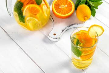 Citrus drink with lemon, orange and mint. Healthy and healthy drink in a transparent glass with copy space