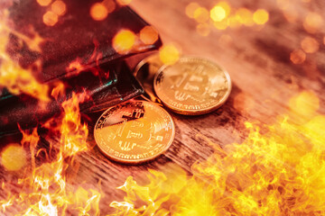 Bitcoin gold coin burning, burning cryptocurrency BTC investment falls, online currency value loss, fire PHOTOMONTAGE
