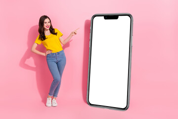 Full size photo of young charming lady promo advise you new telephone model isolated on pink color...