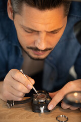 close view of man repairing a wrist watch