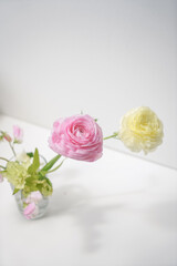 Close-up of a small bouquet of spring flowers on a light background on a white table