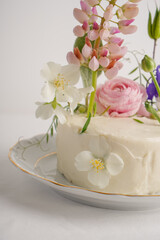 Close-up of a gentle romantic white cake with flowers