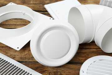 Parts of home ventilation system on wooden surface, closeup