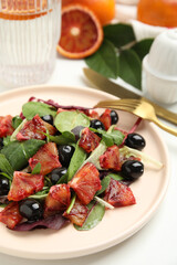 Delicious salad with sicilian orange on white table, closeup