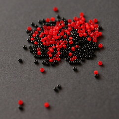 Glass beads isolated on black background. Black and red colors. 