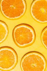 Sliced orange set on yellow background