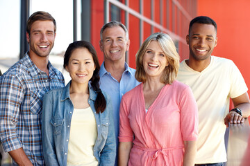 Were all in it together. Portrait of a diverse group of coworkers in a casual office environment.