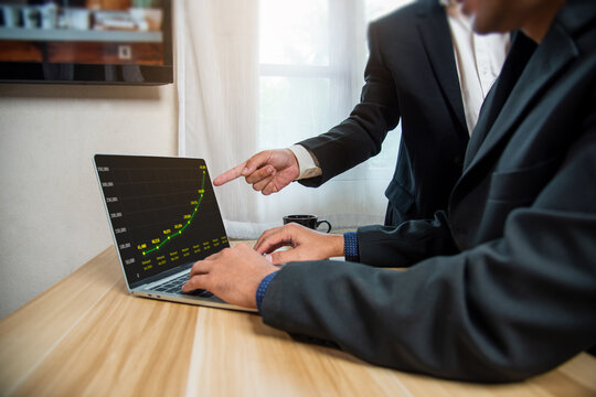Manager's hand pointing out the project's sales and revenue graph analysis., business concept